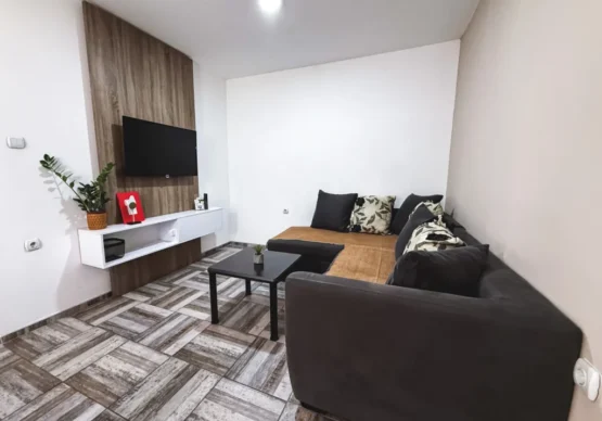 Dnevna soba sa TV-om i ugaonom garniturom u apartmanu Ana 3