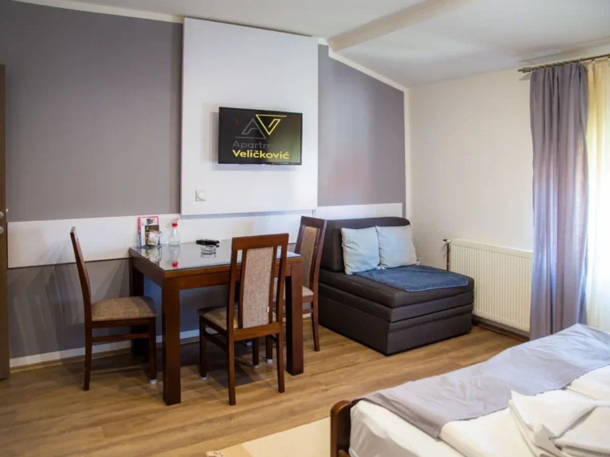 Trpezarijski deo apartmana Ana 6 Trpezarijski sto, televizor i pomoćni ležaj u apartmanu Ana 6
